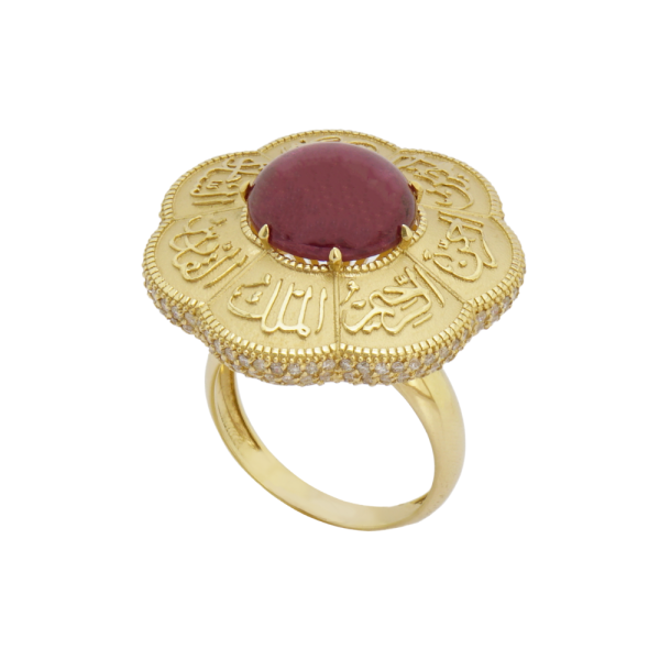 A ring made of 18-karat gold, featuring a large ruby stone and decorative elements around it.