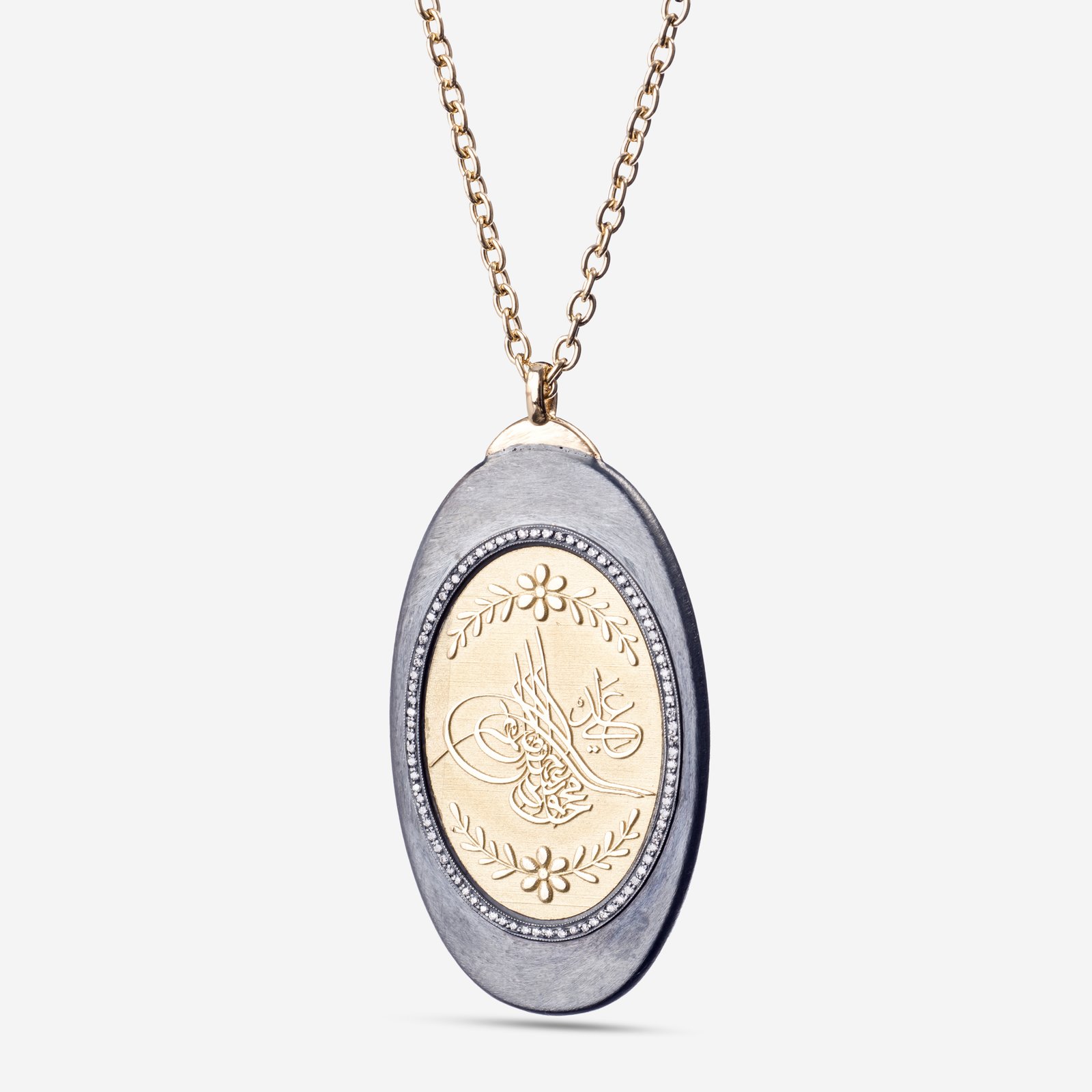 18-karat gold, luxurious necklace with raised gold calligraphy/Kanuni Seal motif on a smoked (black) oval body.