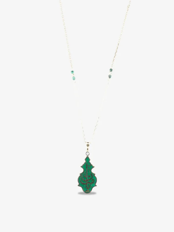 An 18-karat gold pendant with a green enamel base, featuring an Arabic calligraphic inscription reading "Yâ Hafîz" and diamond details in the shape of a candle.