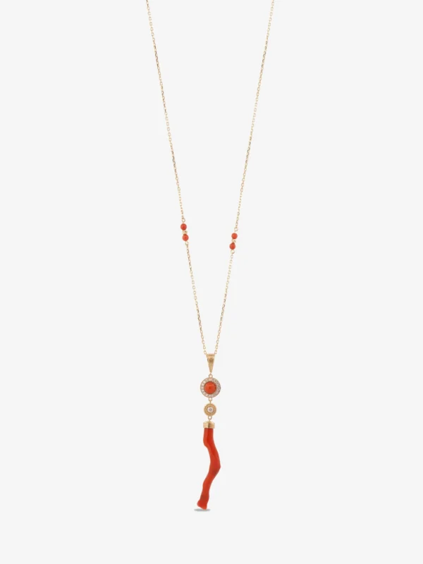 An 18-karat gold chain with a circular coral cabochon surrounded by diamond stones and a curved, natural red coral branch pendant below.